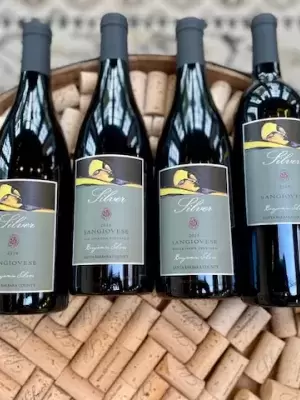 6 bottles laying on top of corks  